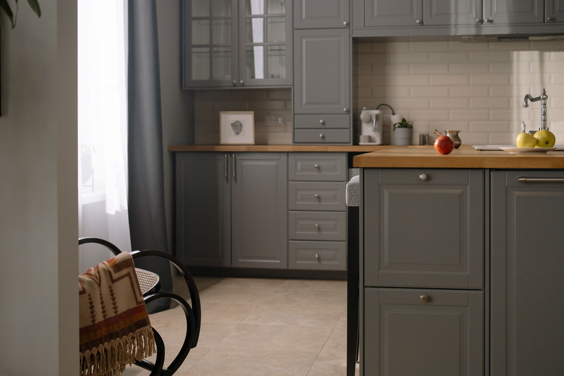 Stylish gray kitchen interior with wooden countertops, natural lighting, and modern design elements in Rancho Cucamonga, CA