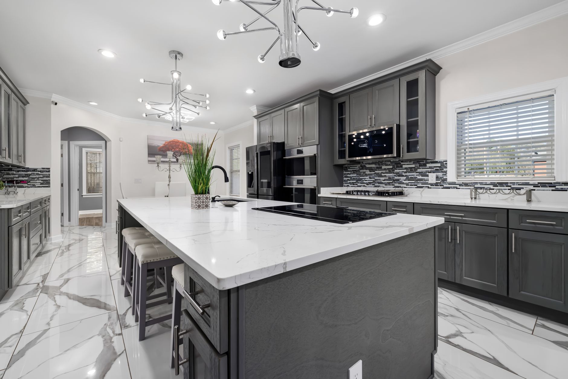 Experience elegance in this luxury modern kitchen featuring marble countertops, sleek cabinetry in Rancho Cucamonga, CA